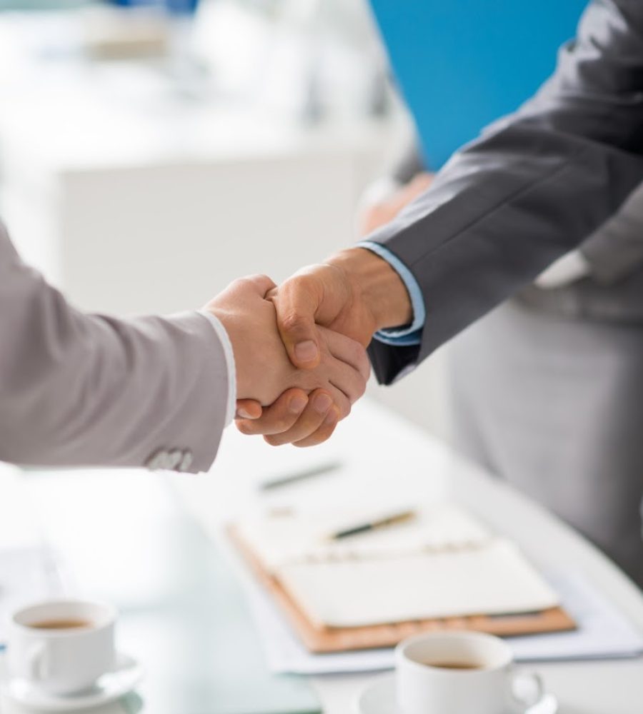 Hands of business people shaking hands after successful meeting